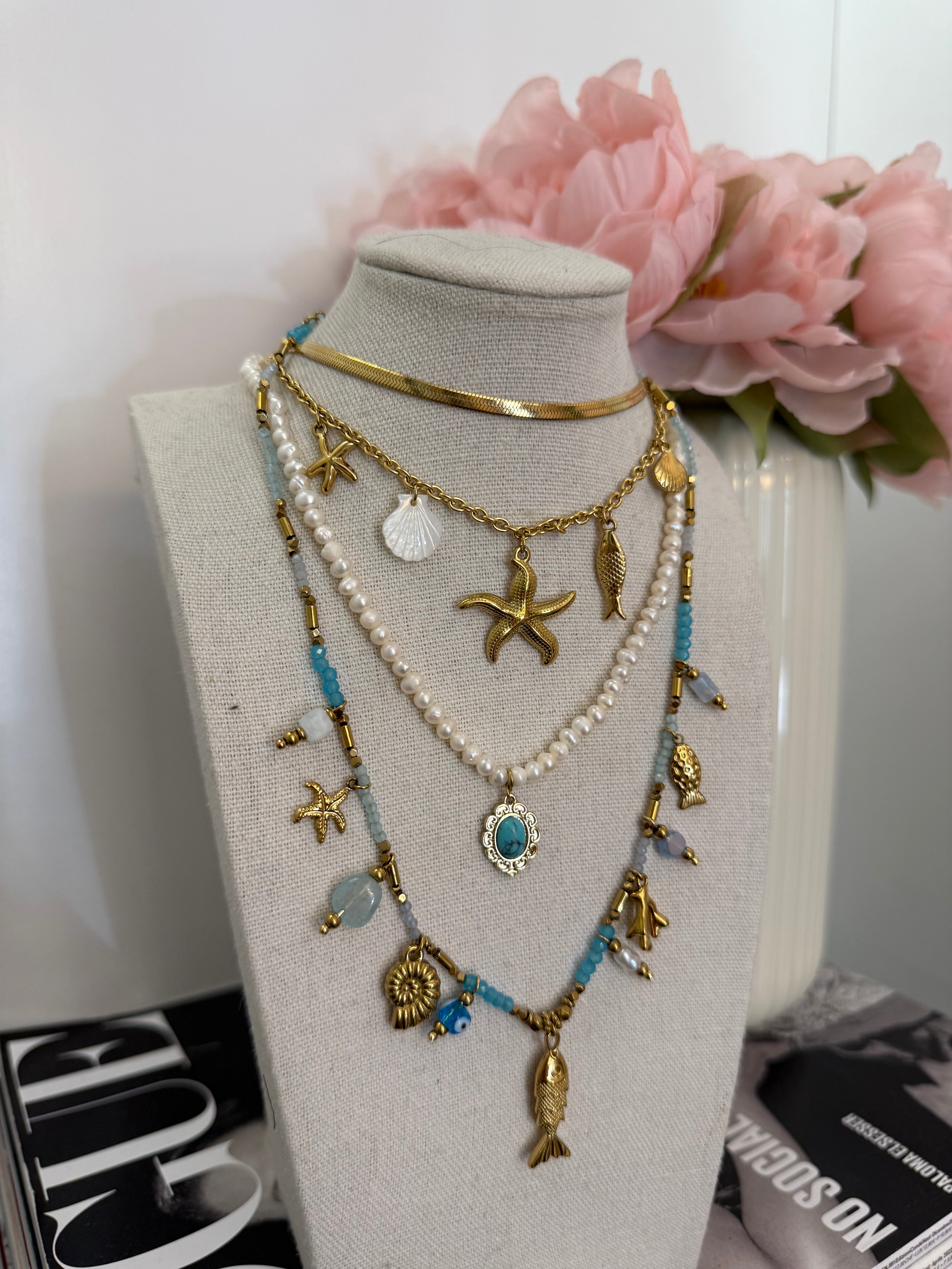 Collana multi charm stella marina e conchiglie